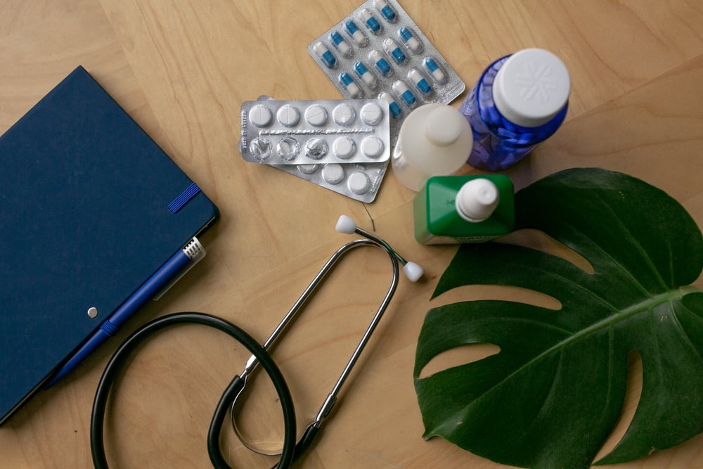 Green Medicine Flatlay of Medicines and Doctor's Equipment